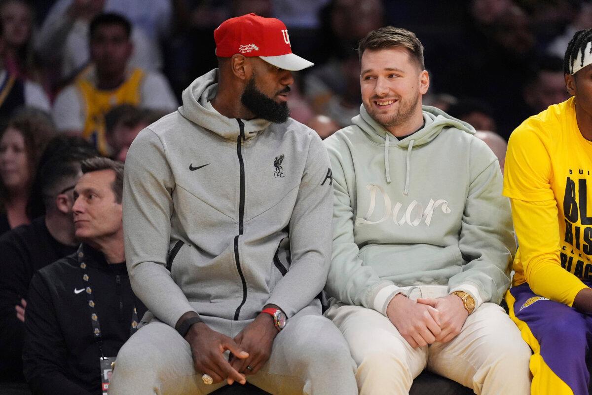 Los Angeles Lakers' LeBron James (L) and Luka Doncic talk during the first half of an NBA basketball game against the Indiana Pacers in Los Angeles on Feb. 8, 2025. (Mark J. Terrill/AP Photo)