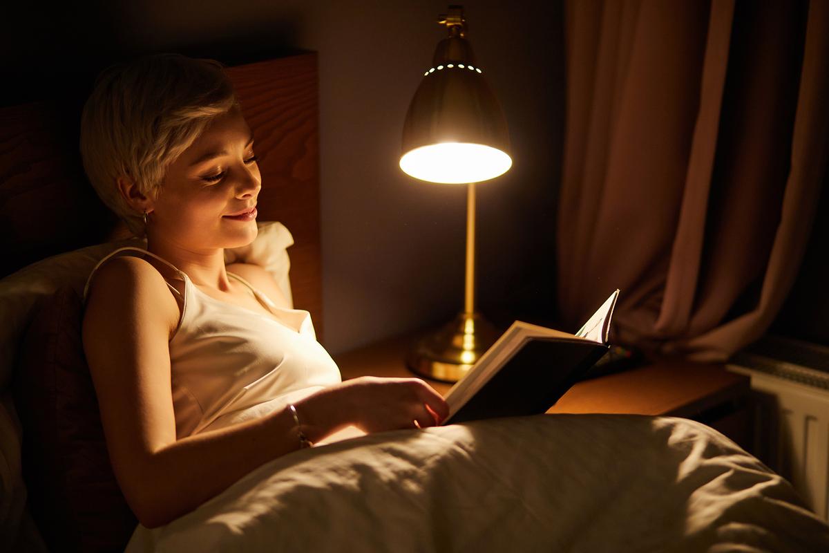 A regular wind-down routine, including a relaxing activity such as reading, can help your brain and body prepare to sleep. (Shakirov Albert/Shutterstock)