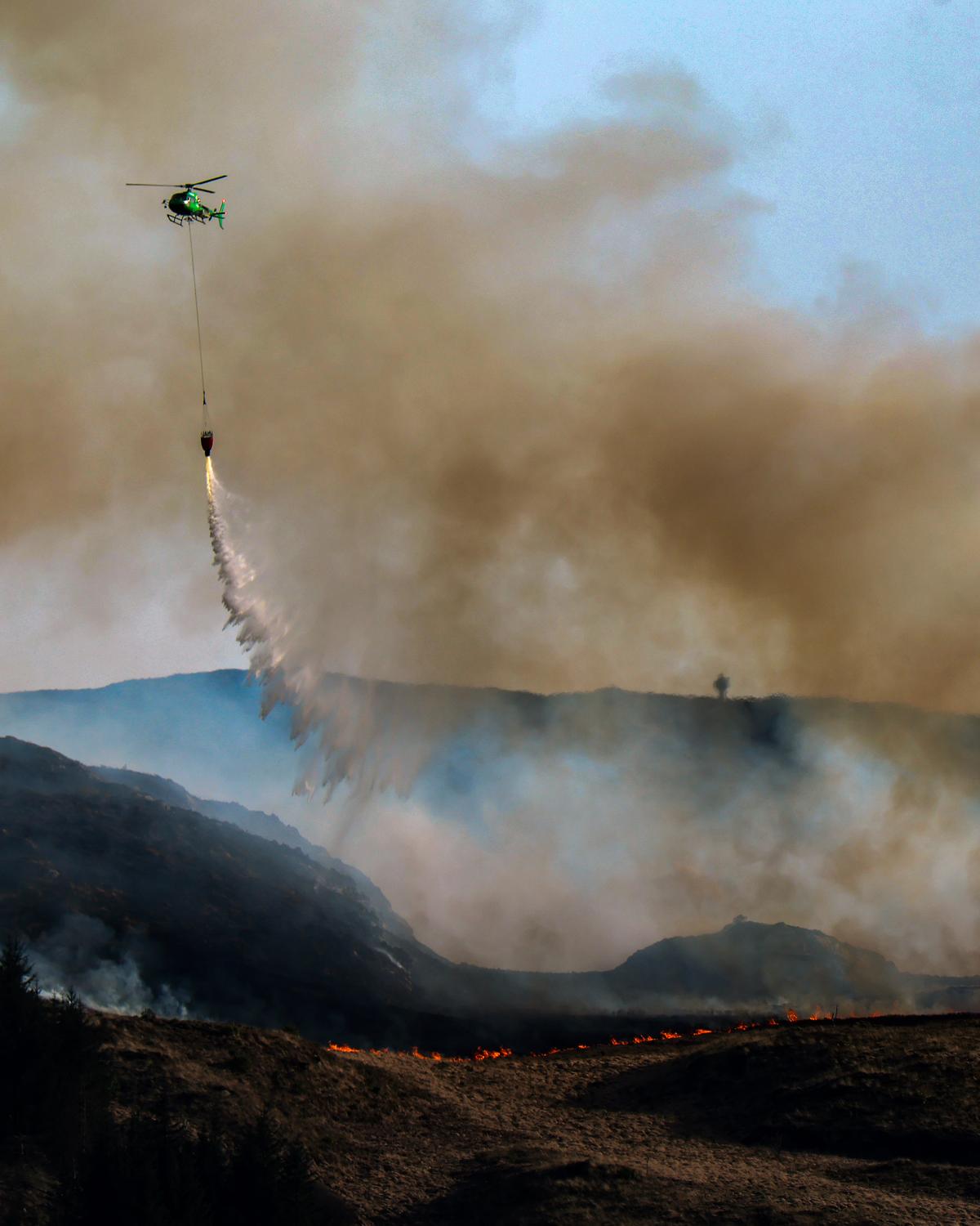 Day in Photos: Forest Fire in Scotland, Dust Storm in Iraq, and High-Security Prison
