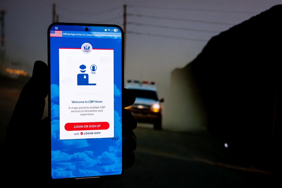 In this photo illustration, a phone displays the CBP Home App on May 5, 2025. (Oleksii Pydsosonnii/The Epoch Times)