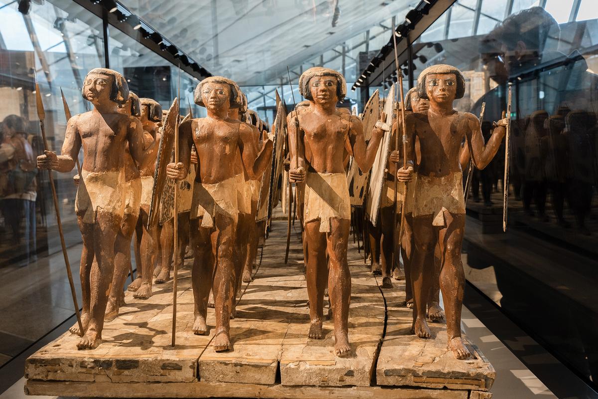 Wooden statues of ancient Egyptian soldiers are on display at the Grand Egyptian Museum. (HitchLens/Shutterstock)