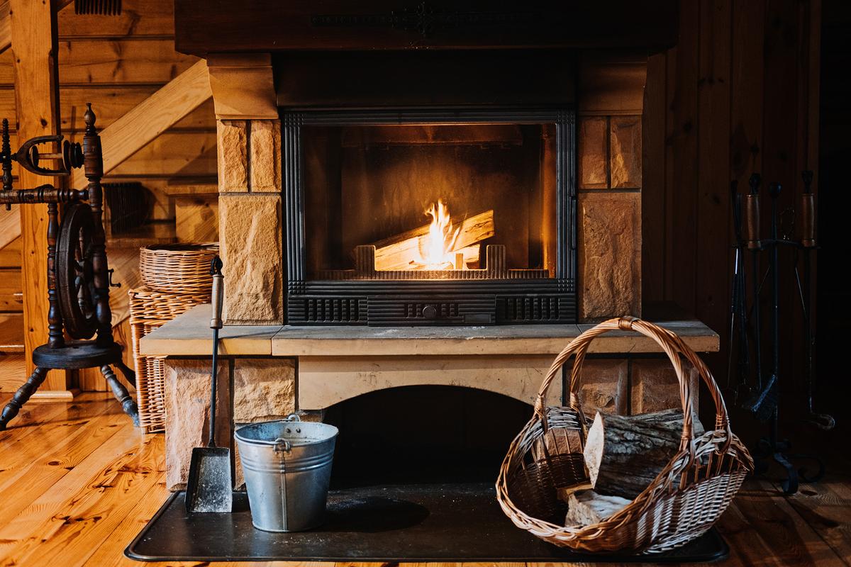 Inspecting the fireplace before winter ensures that it will be free from blockages, damage, or animal nests during the cold season. (Iryna Imago/Shutterstock)