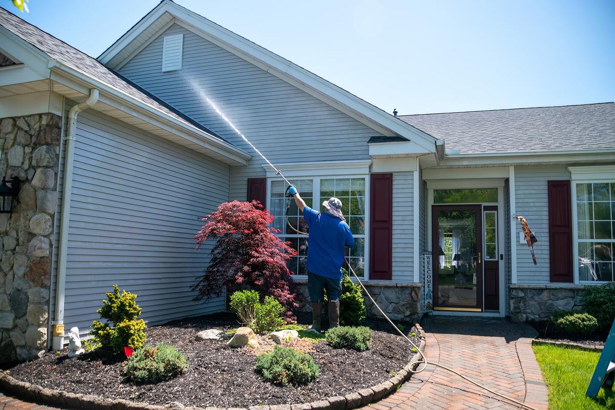 Annual power washing maintains the home's exterior and prevents long-term damage from dirt and mold. (Alan Budman/Shutterstock)