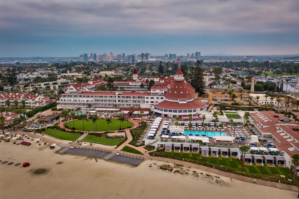 Located on the peninsula of Coronado, the hotel is only seven miles from downtown San Diego. Yet brothers James and Merritt Reid of the 19th-century architectural firm Reid & Reid envisioned an assuming and unique design different from anything the burgeoning city offered. In this aerial view, the abundance of details, the differing pitches and towers, and numerous porches show how the hotel’s creative Victorian Queen Anne appeal contrasts with the vertical monoliths dominating the modern metropolis's skyline. (Manuela Durson/Shutterstock)