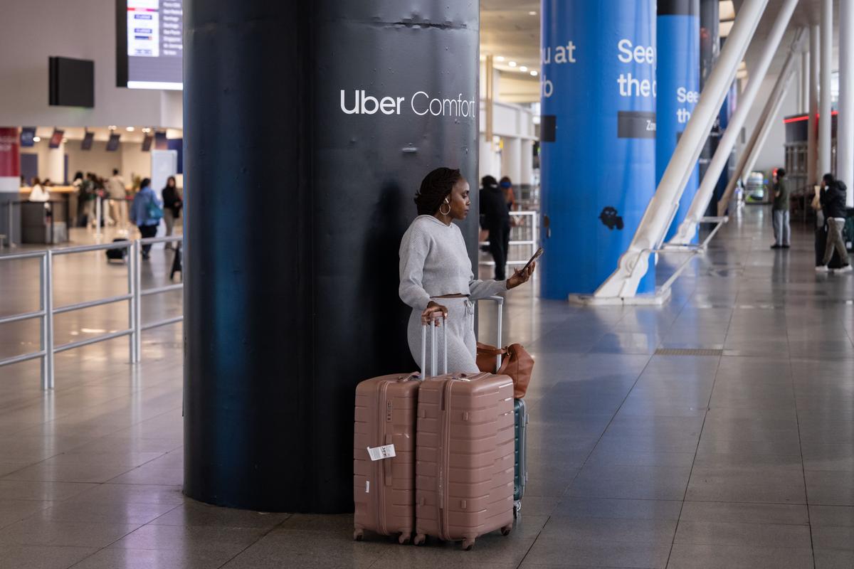 A person makes a phone call after arriving at John F. Kennedy International Airport in New York City on June 9, 2025. (Adam Gray/Getty Images)