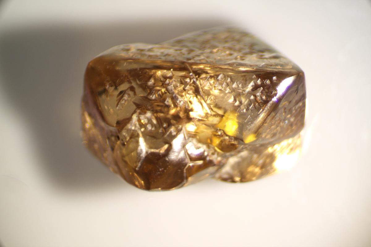 Weighing 3.81 carats, the triangular Duke Diamond shines with a copper-like metallic luster. (Courtesy of Crater of Diamonds State Park)