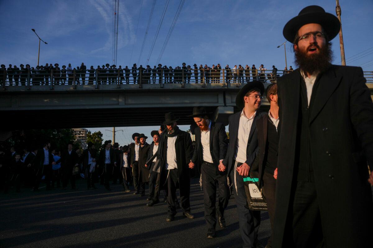 Ultra-Orthodox Jewish men block a highway during a protest against army recruitment in Bnei Brak, Israel, on March 2, 2025. (Ohad Zwigenberg/AP Photo)