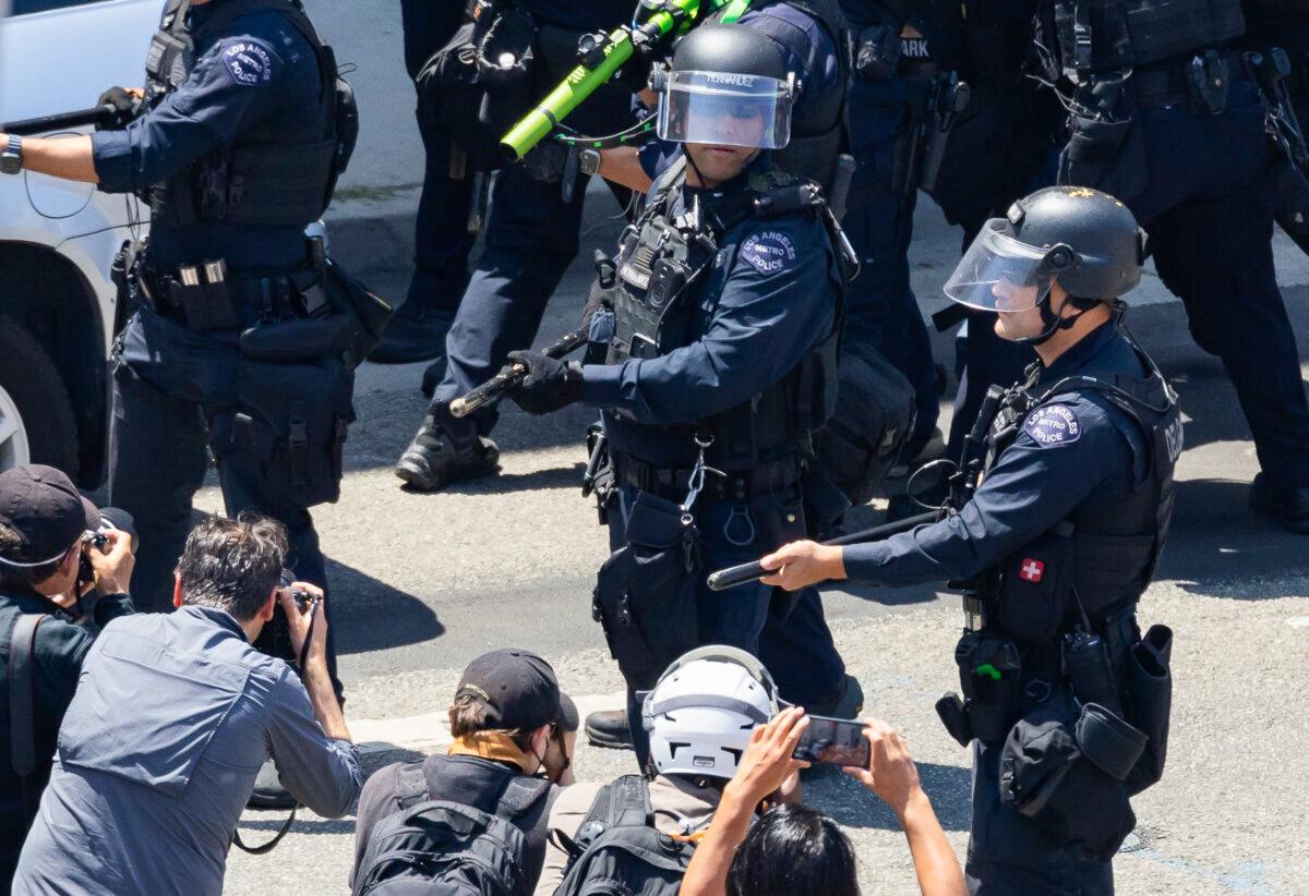 Los Angeles Police Department officers set up a skirmish line to deter protesters in Los Angeles on June 10, 2025. (John Fredricks/The Epoch Times)