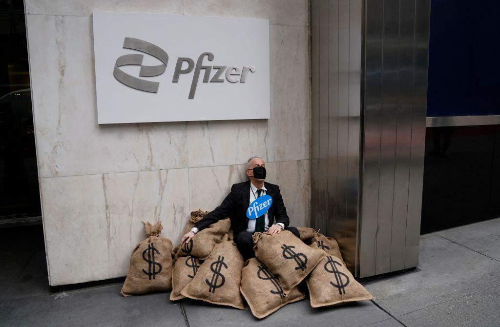 Center for Popular Democracy staged a street-theater simulation of a heist outside Pfizer's New York headquarters on April 25, 2022 to call for equitable global access to coronavirus (COVID-19) vaccines and treatments. (Timothy A. Clary/AFP via Getty Images)