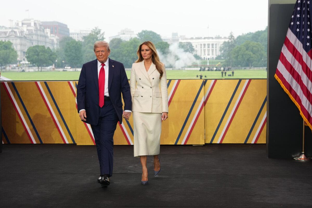 President Donald Trump and First Lady Melania Trump walk on stage during a celebration of the Army's 250th birthday on the National Mall in Washington on June 14, 2025. (Getty Images)