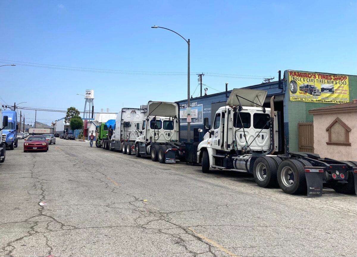 Only a few semitrucks sat awaiting repairs outside of Silva Truck & Auto Electric in Long Beach, Calif., on June 5, 2025. An employee said the street used to be lined with trucks. (Allan Stein/The Epoch Times)