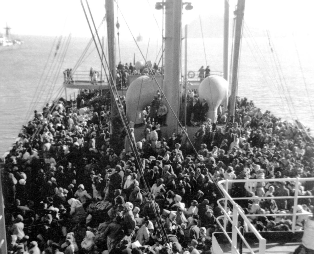 After three days sailing, 14,000 North Korean refugees and five babies, who were born on board the SS Meredith Victory, a U.S. Merchant Marine vessel, arrive at Koje Island, South Korea, on Dec. 26, 1950. (J. Robert Lunney, former Staff officer of SS Meredith Victory via World Peace Freedom United)