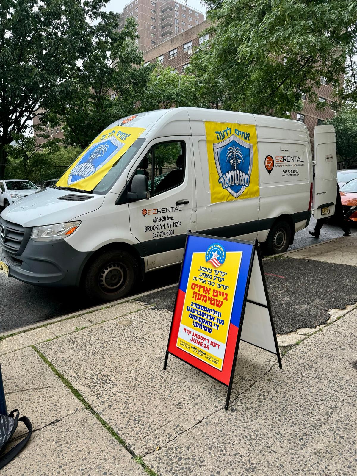 A 'get-out-the-vote' van with Hebrew posters, reading "Every father, every mother, every responsible person goes out and votes," is parked outside a polling place in Williamsburg, Brooklyn, N.Y., on June 17, 2025. (Arjun Singh/The Epoch Times)