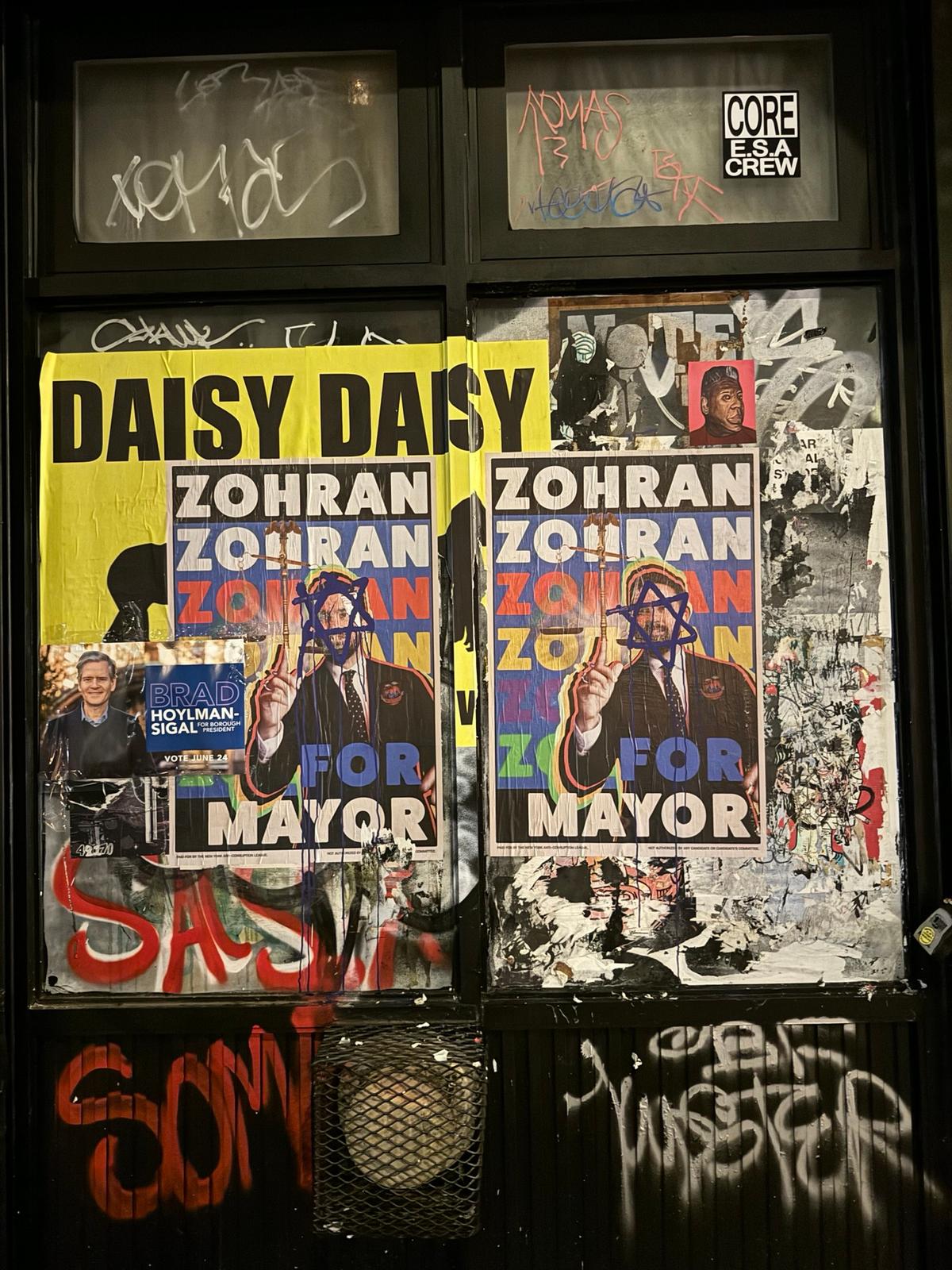 Posters supporting Zohran Mamdani, with graffiti of a Star of David, in the Cooper Square neighborhood of Manhattan, N.Y., on June 18, 2025. (Arjun Singh/The Epoch Times)