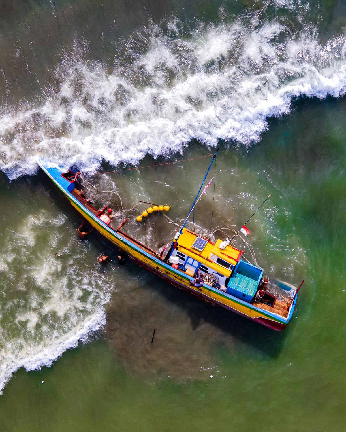 Day in Photos: Ship Capsizes in Indonesia, Forest Fires in Greece, Amazon Launches Satellites