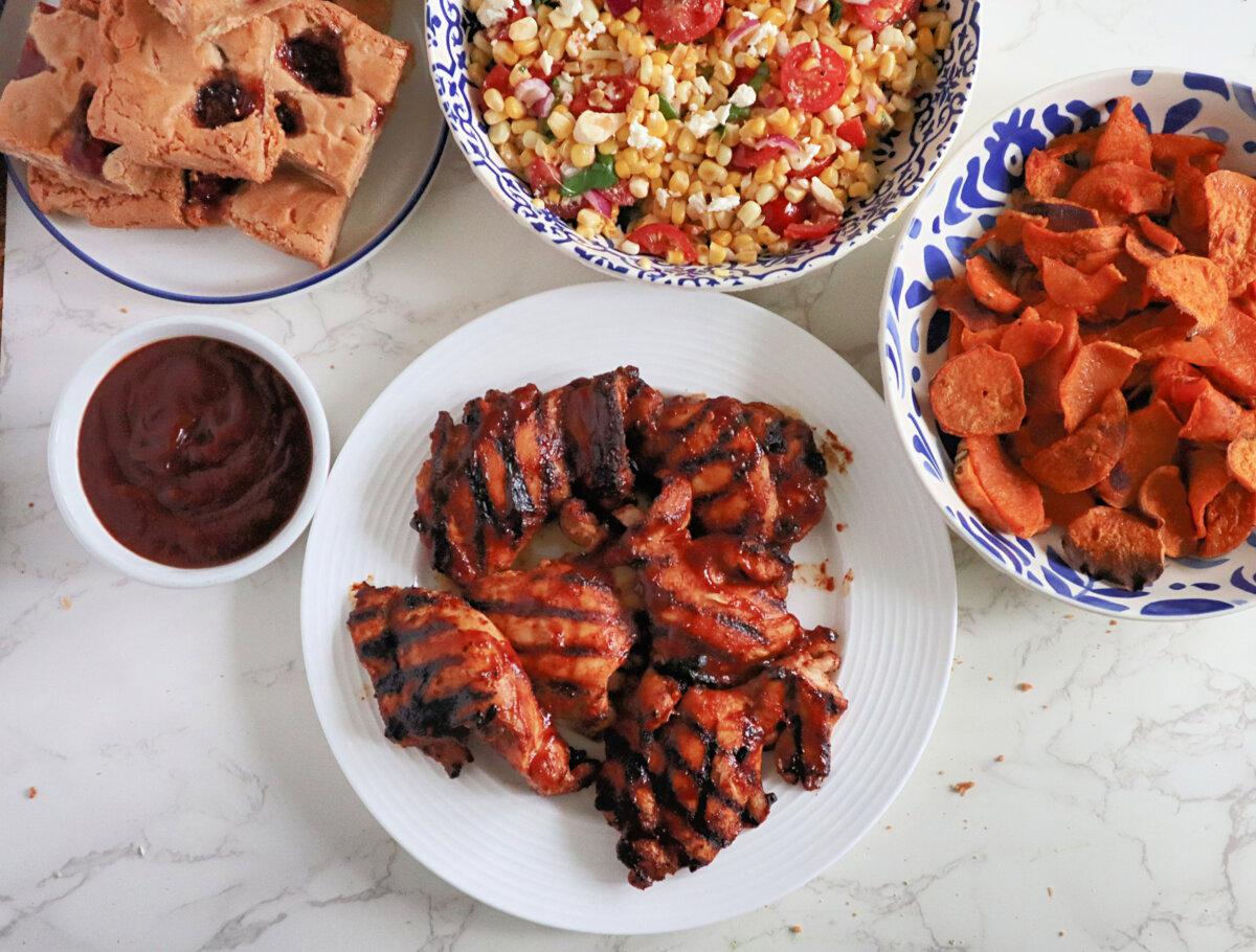 This budget dinner for 4 features a fresh corn salad, roasted sweet potato chips, barbecued boneless chicken thigh, and strawberry-pecan blondies for dessert. (Gretchen McKay/Pittsburgh Post-Gazette/TNS)