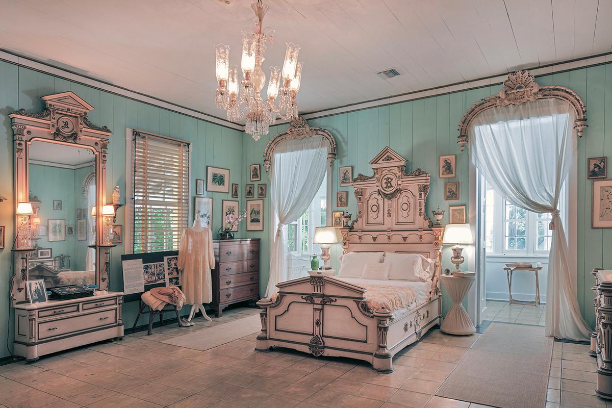 This room’s decor centers on Bartlett’s suite of American Renaissance Revival furnishings, crafted in the mid-1800s. Each piece is carved with classic elements, such as acanthus leaves and urns, as well as the initial “B.” Coordinating with the furnishings are the carved arched door toppers, from which sheer curtains hang; these ornate elements sport a shell design and finials. Behind the bed is an enclosed sunporch that was added in about 1936. (J. Christopher Gernert/Courtesy of Bonnet House)