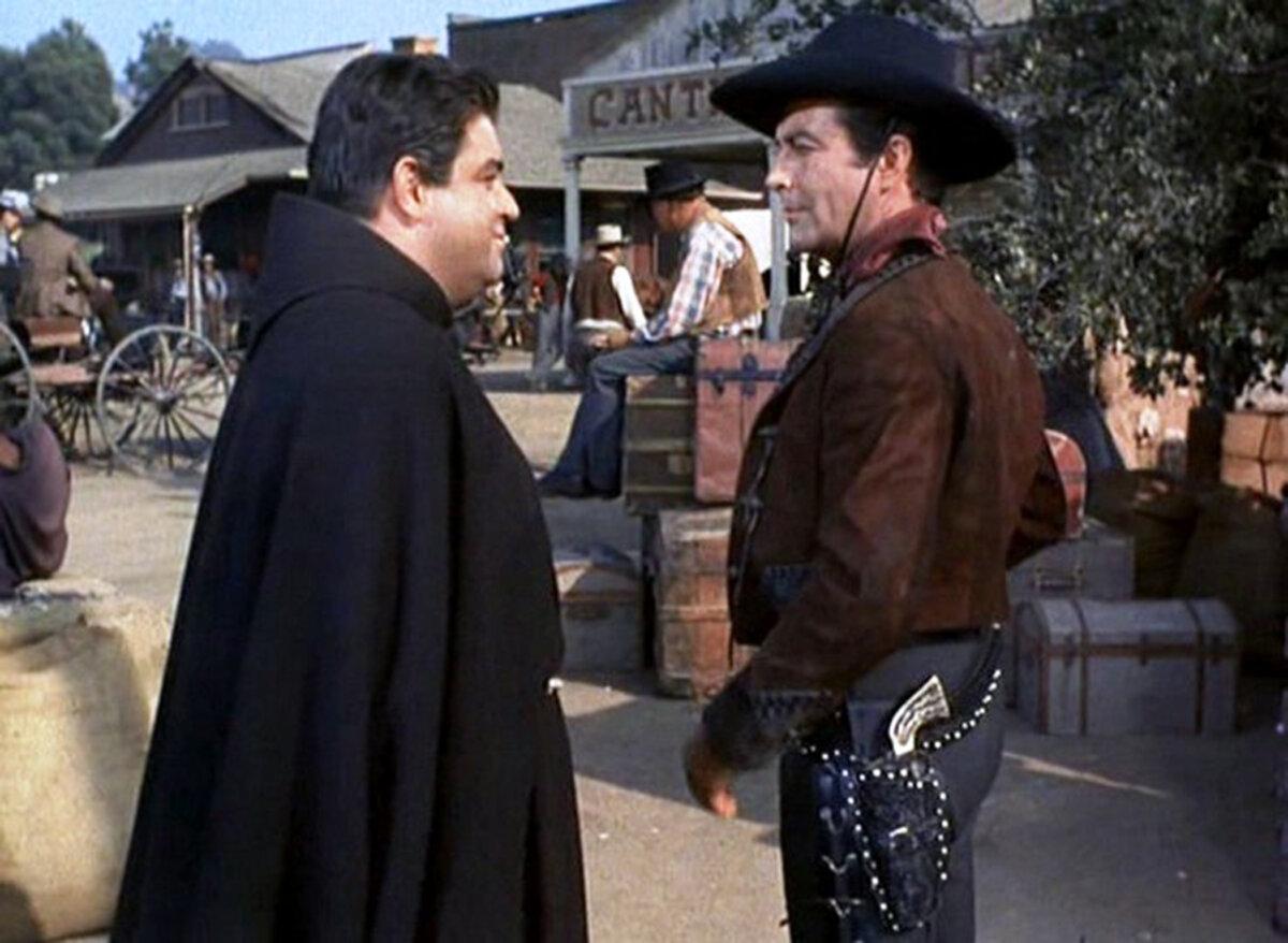 Father Antonio (Kurt Kasznar, L) speaks with Rio (Robert Taylor), in “Ride, Vaquero!” (Metro-Goldwyn-Mayer)