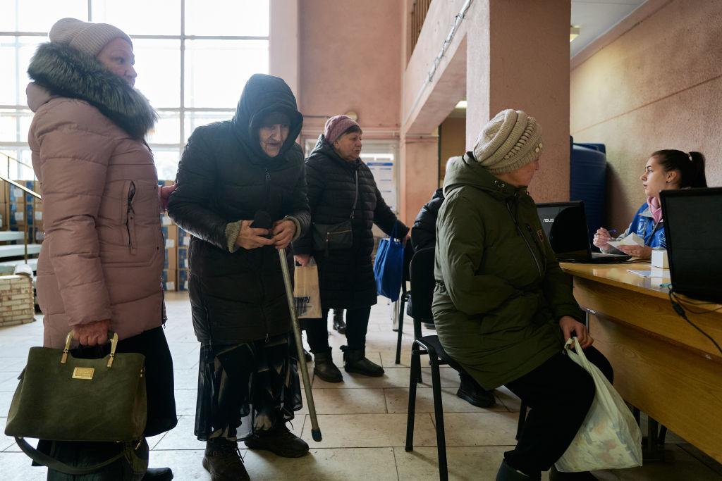 Ukrainian humanitarian workers distribute food rations from the World Food Programme to local residents at a food distribution point run by the Ukrainian charity Angels of Salvation in Druzhkivka, Ukraine, on Feb. 7, 2025. (Pierre Crom/Getty Images).