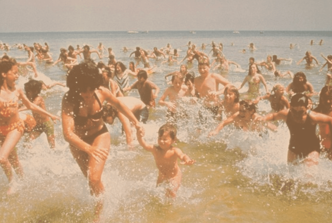 Swimmers flee the ocean in droves when a boy is killed, in "Jaws." (Universal Pictures)