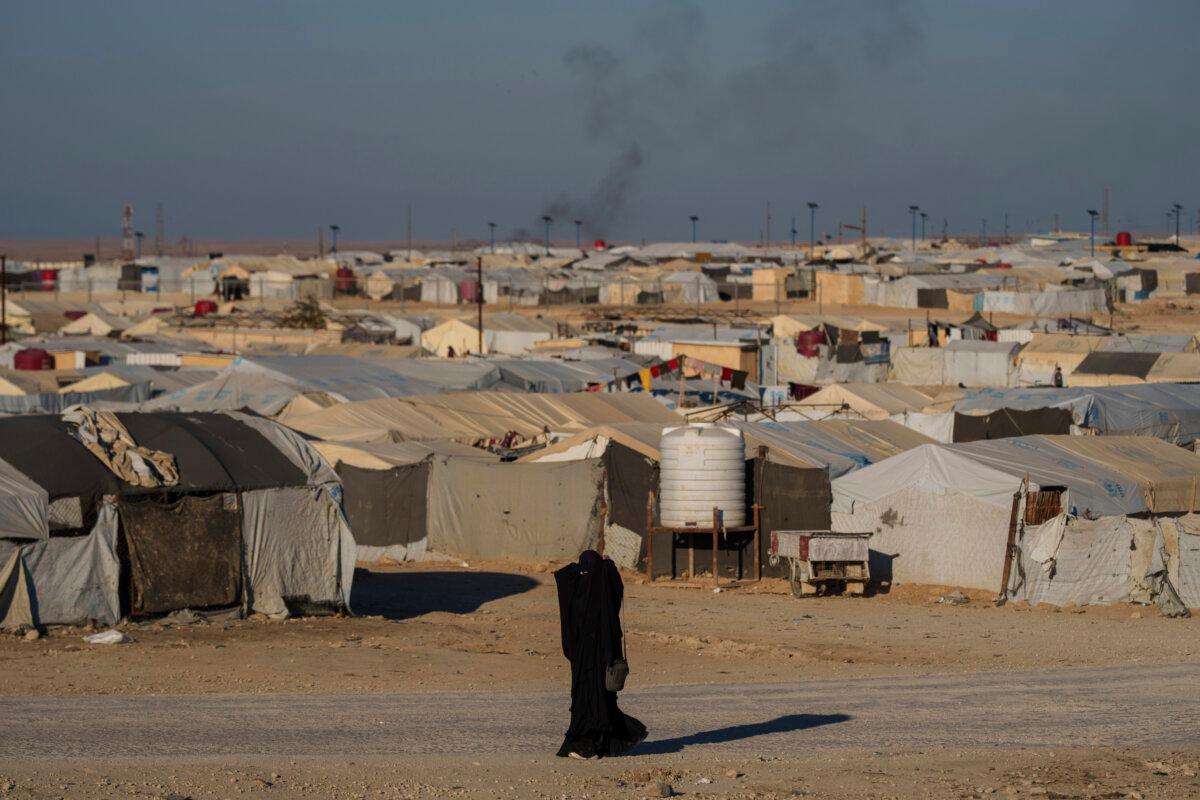 A woman walks in the al-Hol camp in northeastern Syria's Hasakeh province, where tens of thousands of mostly women and children linked to the ISIS terrorist group have been living for years, on Jan. 30, 2025. (Bernat Armangue/AP Photo)