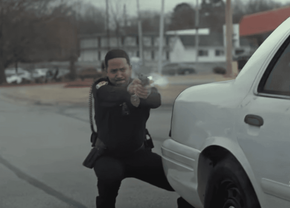 Officer Wray (Chris Greene) fires on AK-47-brandishing suspects, in "Sovereign" (Briarcliff Entertainment)