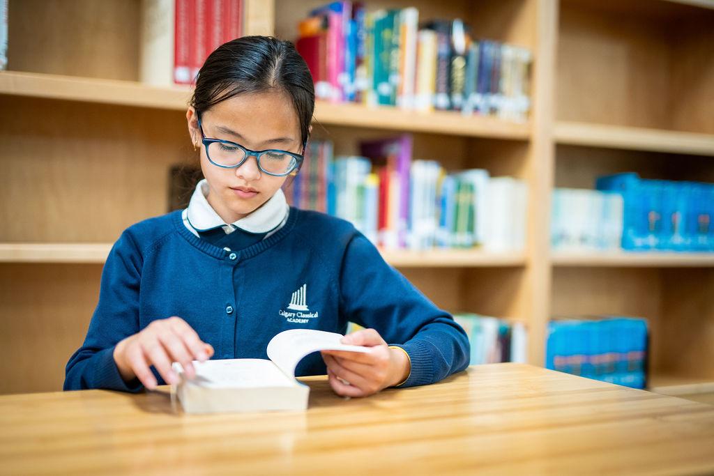 A student at the Alberta Classical Academy reading a book, in an undated photo. (Alberta Classical Academy)