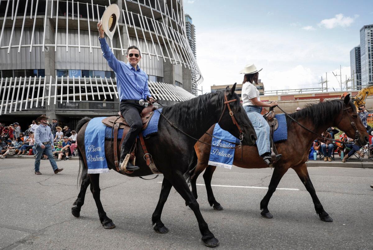 Conservative Leader Pierre Poilievre waves to the crowd as he rides in the Calgary Stampede parade on July 4, 2025. (The Canadian Press/Jeff McIntosh)