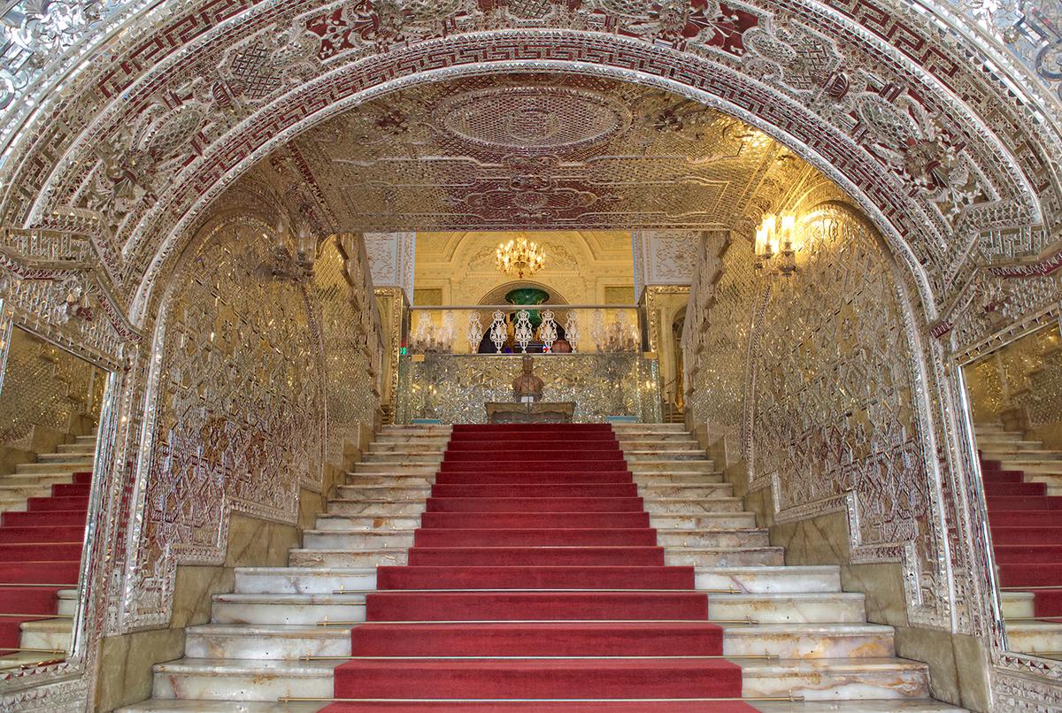 The arched staircase leading to the Salam Hall features mirror mosaics in geometric and flower designs. The marble stairs incorporate intricately carved marble handrails. (Renata Apanaviciene/Shutterstock)