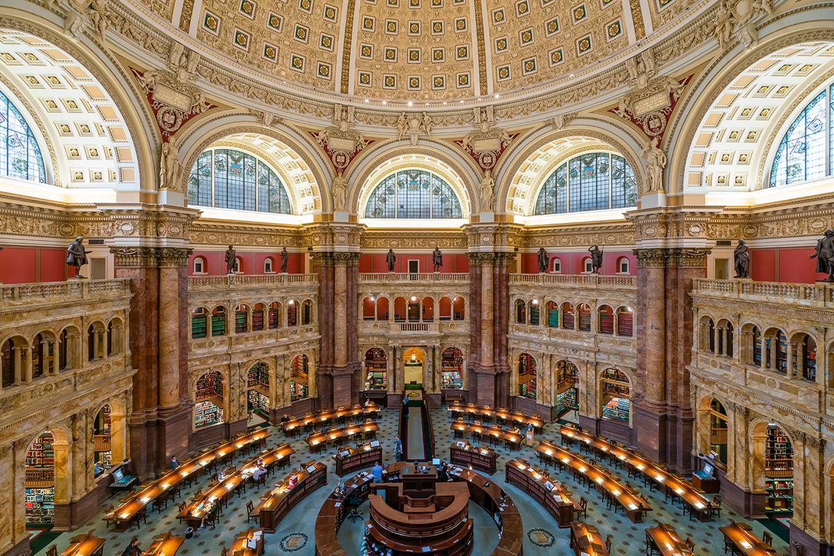 Marble, bronze, gold, mahogany, and many other types of materials were cast, sculpted, and inset to achieve the main Reading Room’s awe-inspiring architecture. The Room is situated under the building’s centrally located dome. Supporting deep inset arches with stained glass windows are eight giant Numidian (North African) marble columns, on which 10-foot-high allegorical female figures in plaster are perched; they represent religion, commerce, history, art, philosophy, poetry, law, and science. Bronze statues at the railing above the portico represent historical figures, including William Shakespeare, Michelangelo, and Ludwig van Beethoven. (ymgerman/Shutterstock)