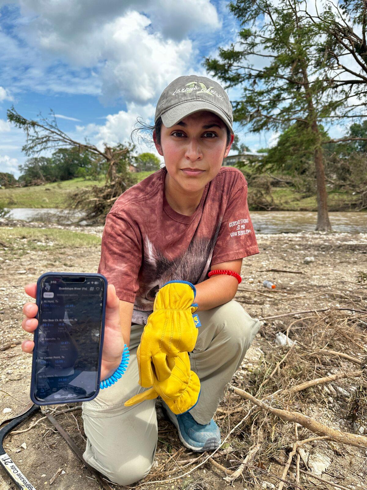 Lillian Sanchez, a Kerrville resident, has a phone app that tracks water flow in case of flooding. She volunteered to clean up debris at an RV resort in Center Point, Texas, on July 7, 2025. (Darlene McCormick Sanchez/The Epoch Times)
