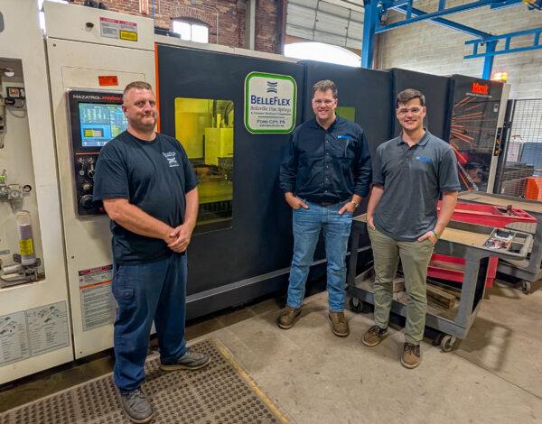 The Mazak fiber laser cutting machine at BelleFlex Technologies, LLC, that cut 695 panels for the raccoon sculpture. Pictured are, from left to right, Operator Jake Reesman, General Manager John Bach, and Engineer Chris Hess, all of whom worked on the project. (Courtesy of Anders Corr)