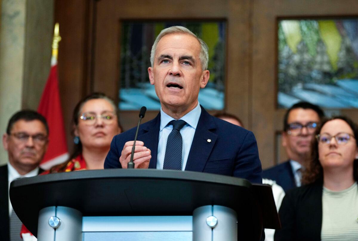 Prime Minister Mark Carney is joined by members of his cabinet and caucus as he speaks at a news conference in the foyer of the House of Commons after Bill C-5 passed in the House, on June 20, 2025. (The Canadian Press/Justin Tang)