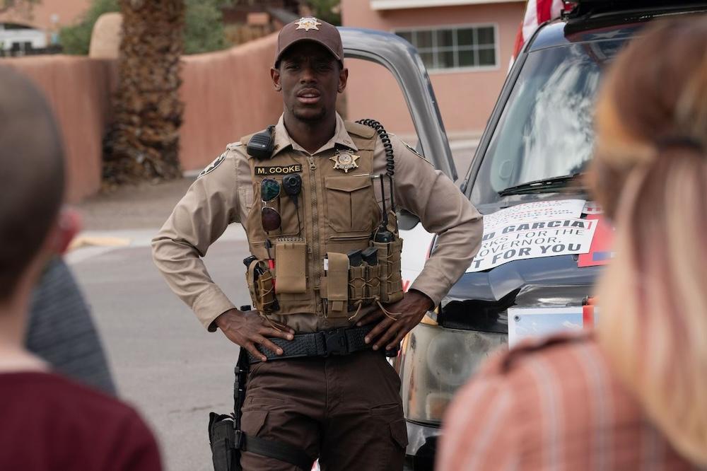 Officer Michael (Micheal Ward, center) monitoring a protest in "Eddington." (A24)