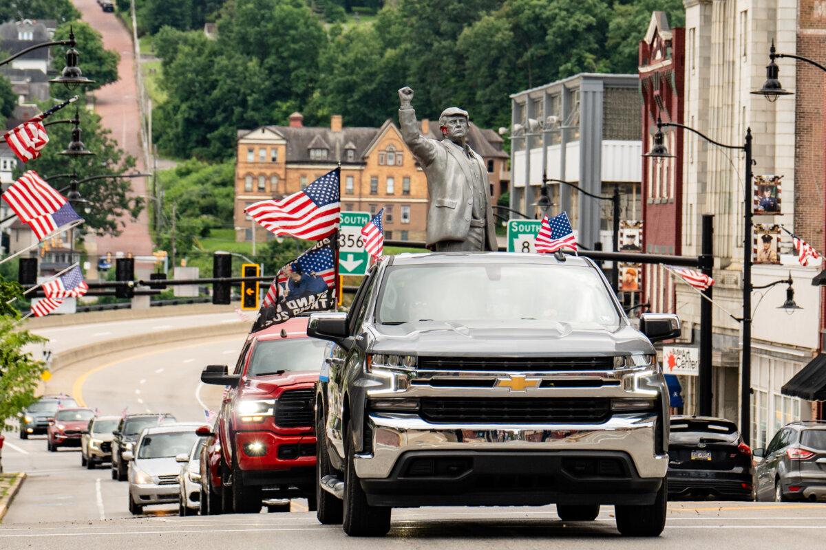 A caravan carries a sculpture of President Donald Trump, based on his survival of an assassination attempt the year before at his campaign rally in Butler, Pa., on July 13, 2025. (Samira Bouaou/The Epoch Times)