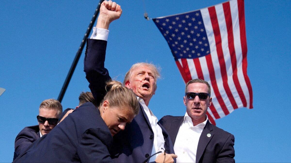 A bloodied Donald Trump, then a presidential candidate, is hustled from the stage by Secret Service agents in Butler, Pa., on July 13, 2024. (AP)