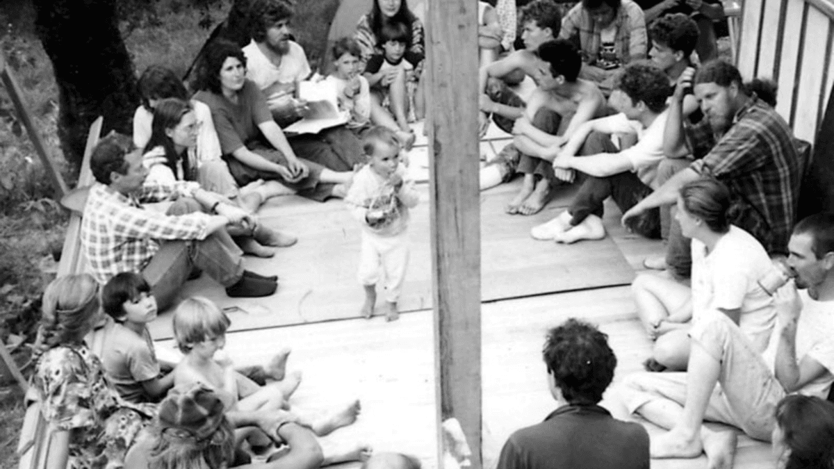 A gathering of members of the Black Bear Ranch commune, in "Commune." (Jonathan Berman)