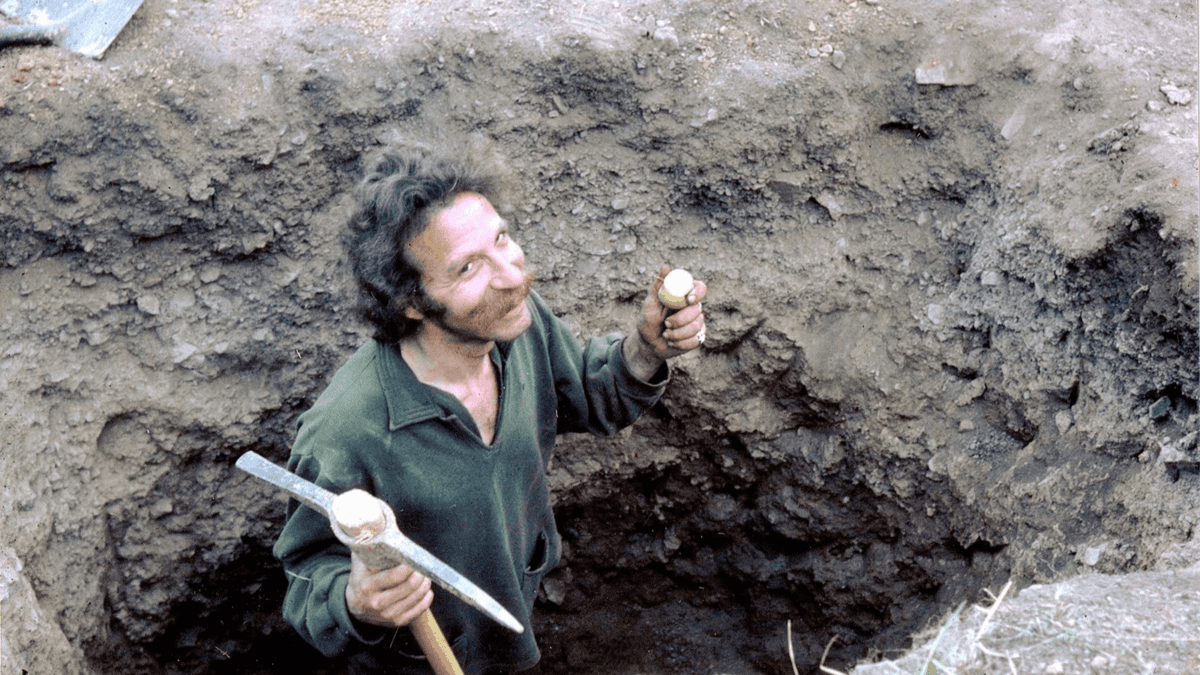 Member of the Black Bear Ranch commune doing a little construction, but since the commune sits on an abandoned mine, he might also be digging for gold, in "Commune." (Jonathan Berman)