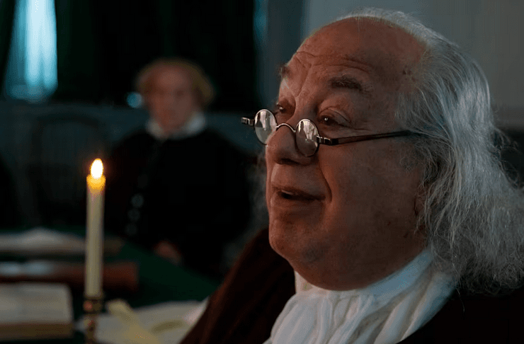 Benjamin Franklin (Barry Stevens) reminding delegates that they must request divine guidance in morning prayer sessions, in “The American Miracle: Our Nation Is No Accident.” (Heroic Pictures/Fathom Entertainment)