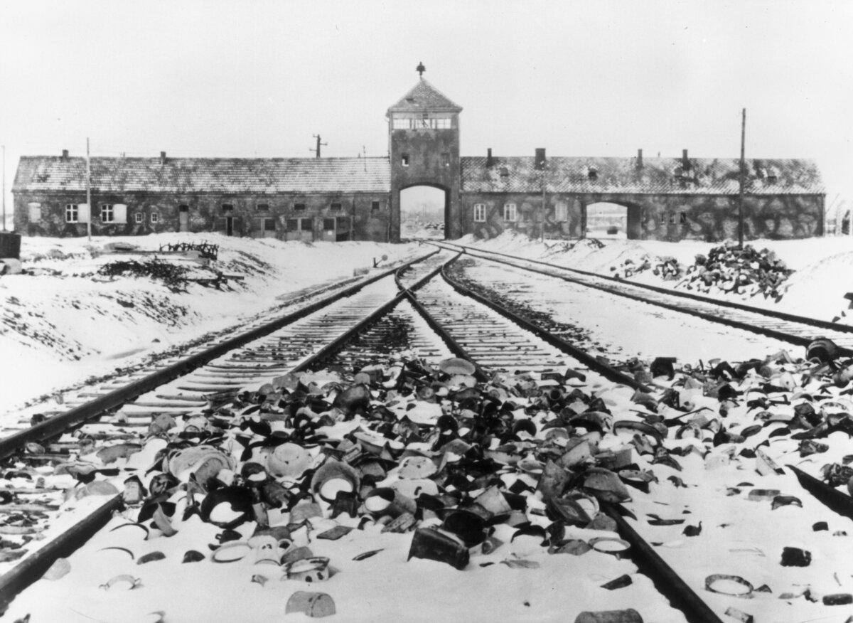 Snow-covered personal effects of those deported to the Auschwitz concentration camp in Poland litter the train tracks leading to the camp's entrance. (Hulton Archive/Getty Images)