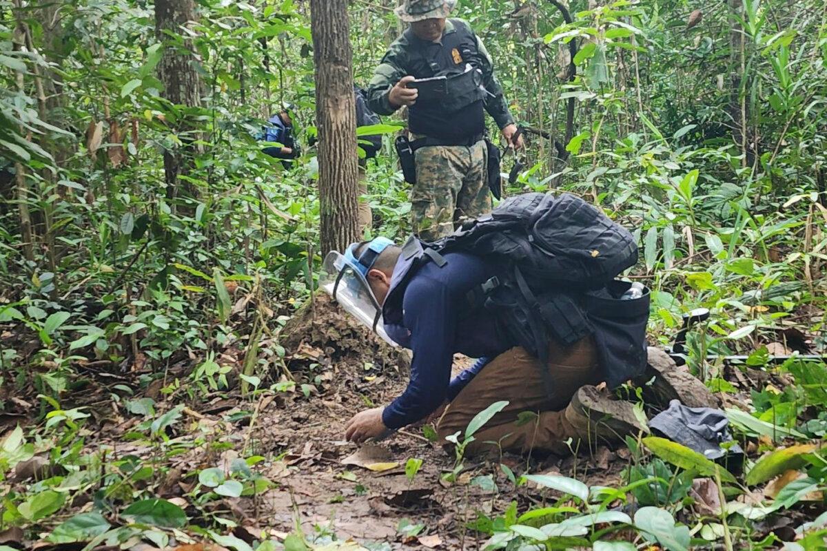 Thai soldiers inspect an area where the Royal Thai Army stated that two anti-personnel land mines were found, at a border area in Ubon Ratchathani Province, Thailand, on July 21, 2025. (Royal Thai Army via AP)