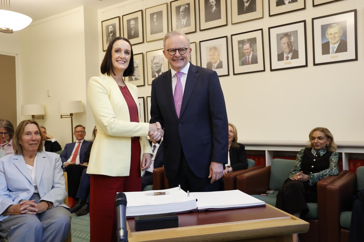 Sarah Witty (L) shakes hands with Anthony Albanese (R) after signing the Labor Caucus book during the first caucus meeting of the 48th Parliament in Canberra, Australia on May 9, 2025. (Hilary Wardhaugh/Getty Images)