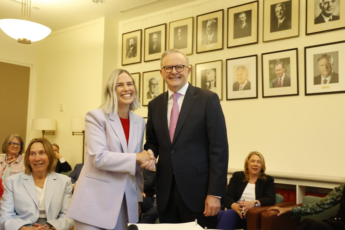Renee Coffey (L) shakes hands with Anthony Albanese (R) after signing the Labor Caucus book during the first caucus meeting of the 48th Parliament in Canberra, Australia on May 9, 2025. (Hilary Wardhaugh/Getty Images)