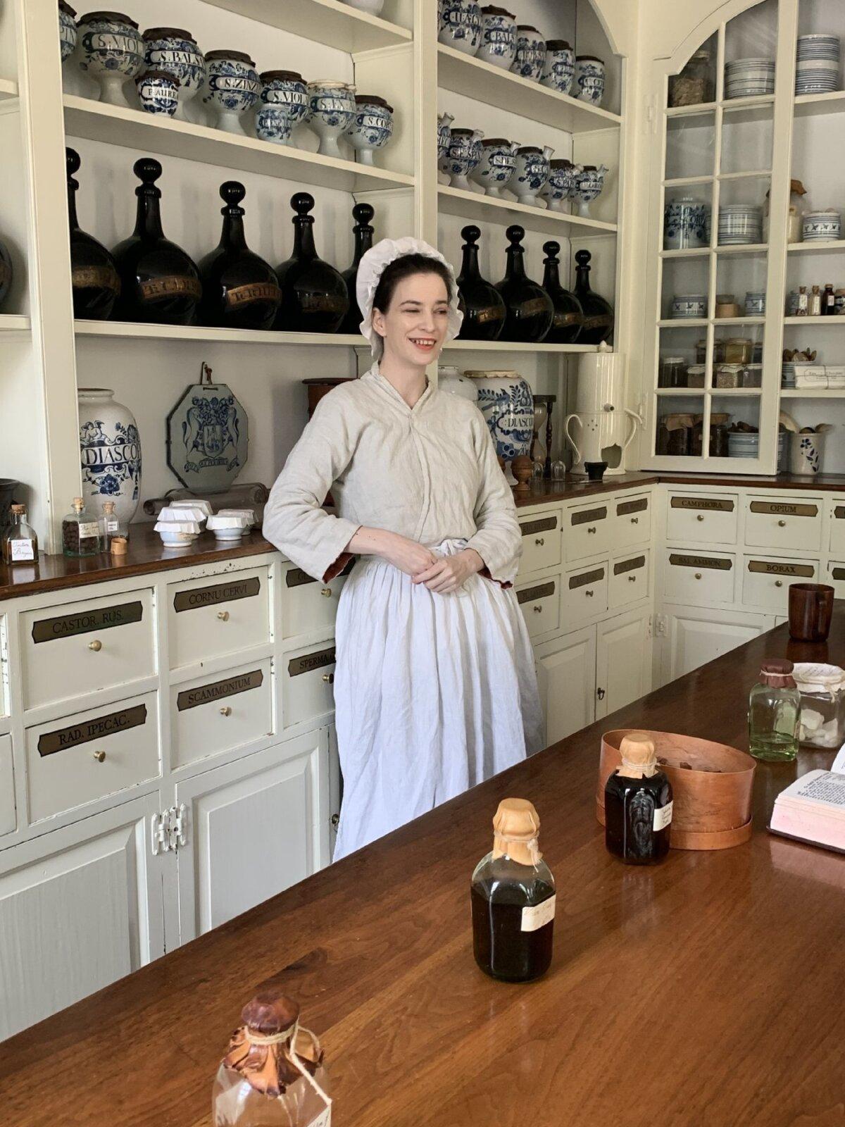 A guide answers visitors' questions at an apothecary in Colonial Williamsburg, Virginia. (Sharon Whitley Larsen)