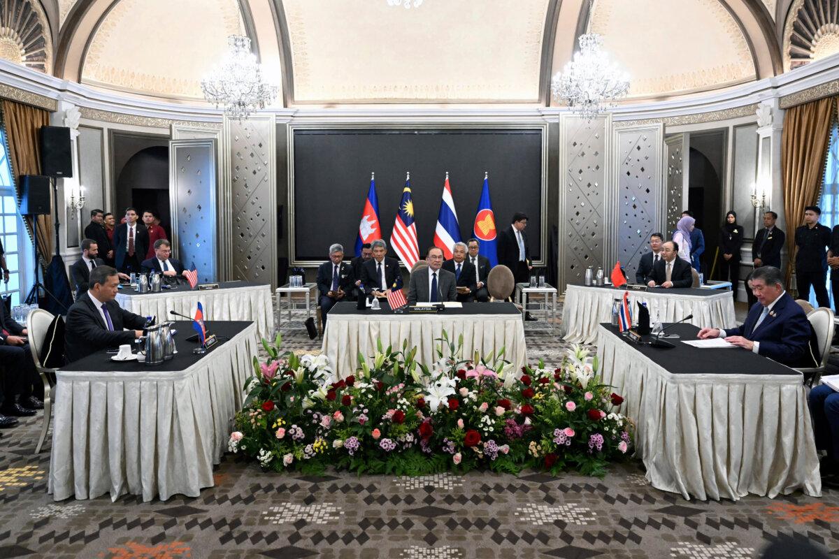 Malaysia's Prime Minister Anwar Ibrahim, (C), looks on as Cambodia's Prime Minister Hun Manet, (L), and Thailand's acting Prime Minister Phumtham Wechayachai, (R), take part in talks on a possible cease-fire between Thailand and Cambodia, in Putrajaya, Malaysia on July 28, 2025. (Mohd Rasfan/Pool Photo via AP)