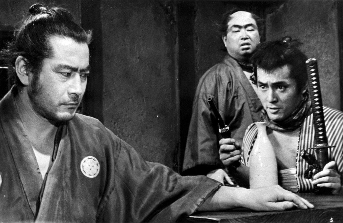 Yojimbo (Toshiro Mifune, L) collides with Unosuke (Tatsuya Nakadai), with Inokichi (Daisuke Kato) looking on, in “Yojimbo.” (Toho)
