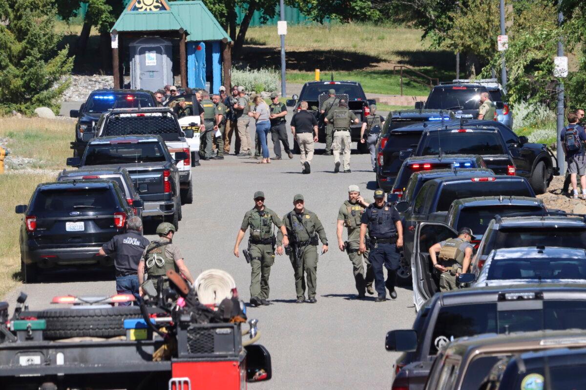 Law enforcement and emergency responders at Cherry Hill Park off 15th Street on June 29, 2025, following reports of an ambush shooting attack on Canfield Mountain, in Coeur d'Alene, Idaho. (Bill Buley/Coeur D'Alene Press via AP)