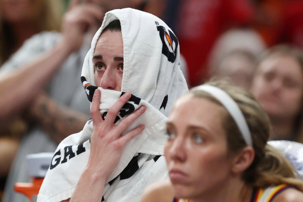 Indiana Fever's Caitlin Clark sits on the bench after an apparent injury during the second half of a WNBA basketball game against the Connecticut Sun in Boston on July 15, 2025. (Michael Dwyer/AP Photo)