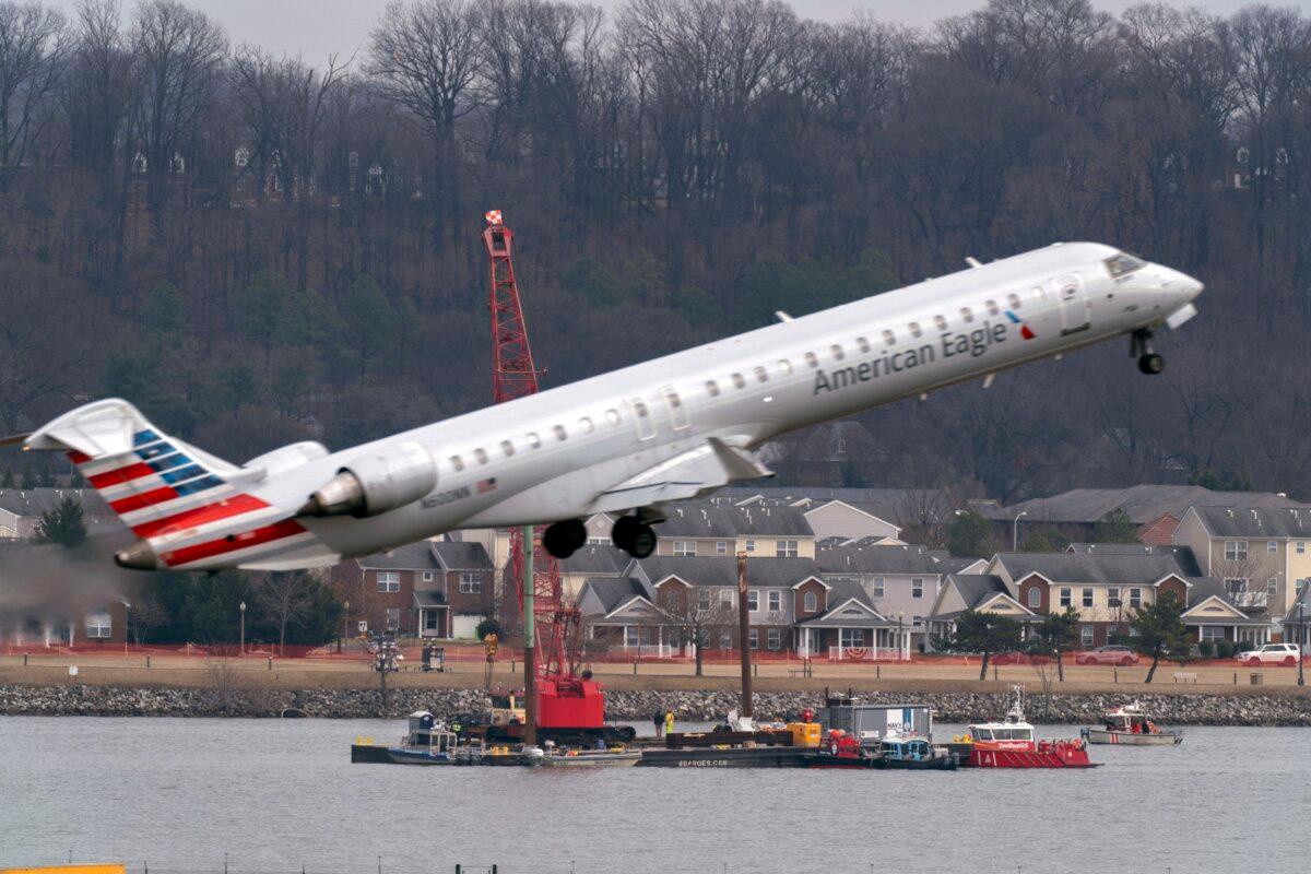 Salvage crews work on recovering wreckage near the site in the Potomac River of a midair collision between an American Airlines jet and a Black Hawk helicopter at Ronald Reagan Washington National Airport, in Arlington, Va., on Feb. 6, 2025. (Jose Luis Magana/AP Photo)