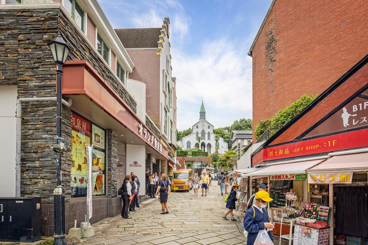 Pedestrians visit shops; Oura Cathedral, also known as Oura Church, stands in the background. (Nigel Jarvis/Shutterstock)